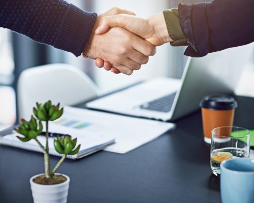 Youve got the job. Cropped shot of two unrecognizable businesspeople shaking hands in the office